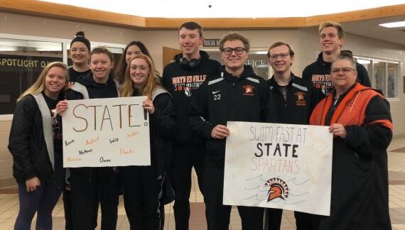 group of people holding a sign